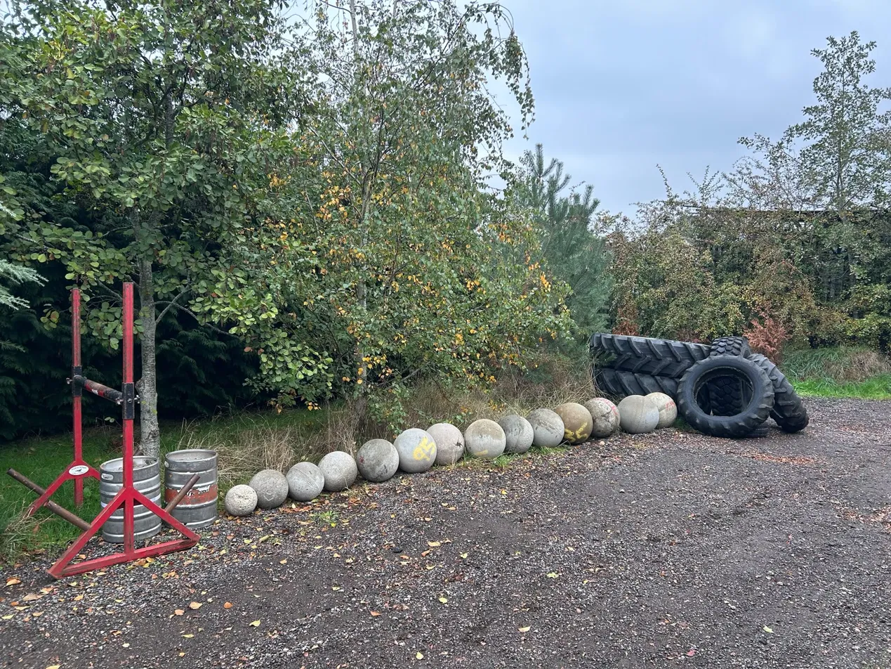 a line of different sized atlas stones and tractor tyres